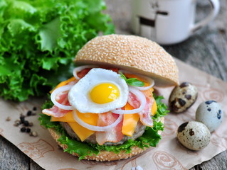 Hamburger with an egg, bacon, cheese and onion