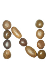 collection of letters of sea stones close-up isolated on white b