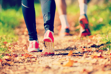 Young couple jogging in park at morning. Health and fitness.