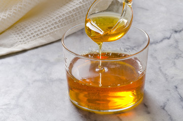 Agave syrup pouring on a glass.
