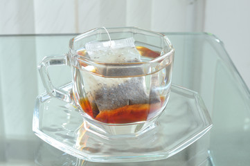Hot water in cup with tea bag, tea-break