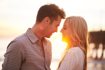 romantic couple at sunset about to kiss