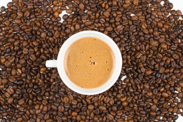 Coffee cup and beans on a background.