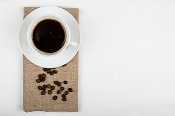 Coffee cup and beans on a white background.