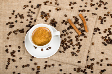 Coffee cup and beans on a background.