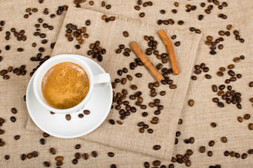 Coffee cup and beans on a background.