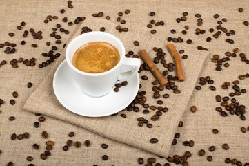 Coffee cup and beans on a background.