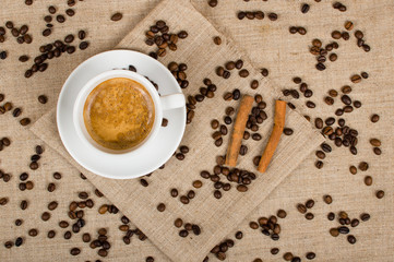 Coffee cup and beans on a background.
