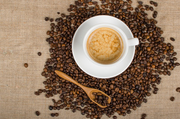 Coffee cup and beans on a background.