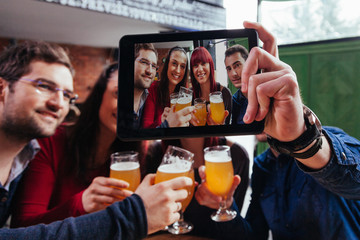 Group Of Friends In Tavern Taking Selfie