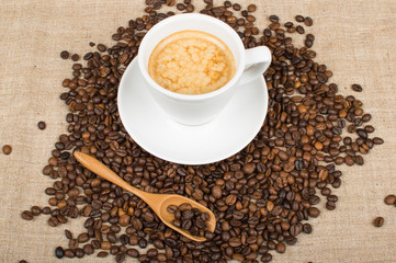 Coffee cup and beans on a background.