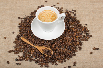 Coffee cup and beans on a background.