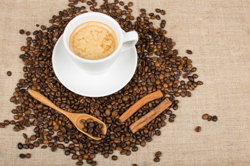 Coffee cup and beans on a background.