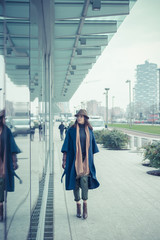Beautiful young brunette posing in the city streets