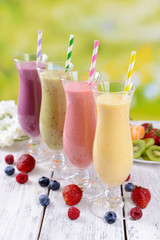 Delicious berry cocktails on table on bright background