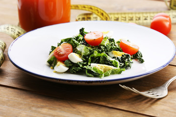 Salad with quail egg and basil in plate