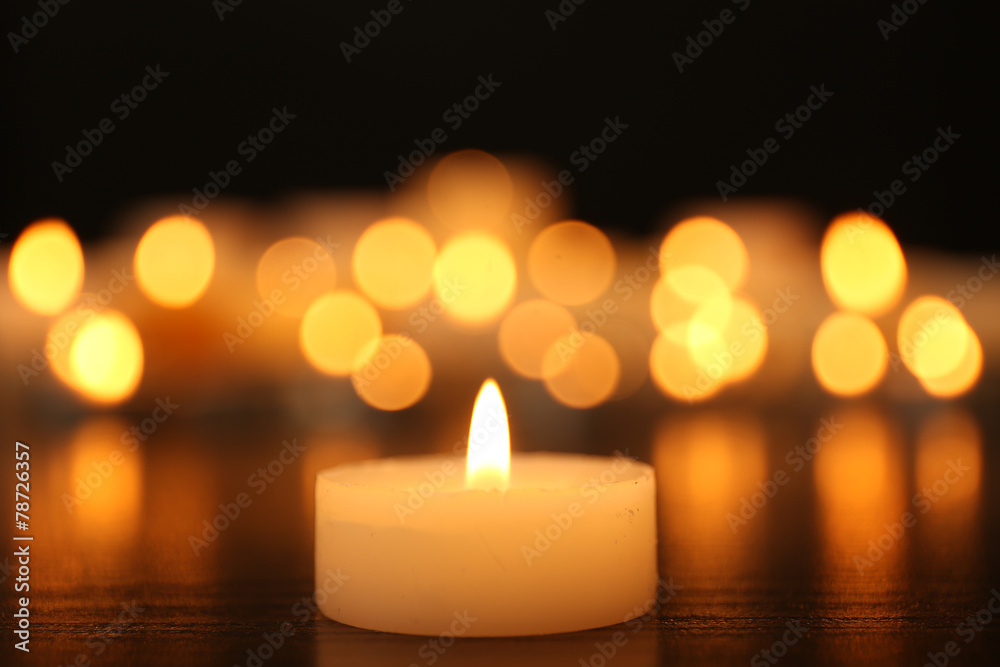 Wall mural burning candles on dark background