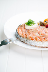 Grilled Salmon with Fresh vegetables on white background