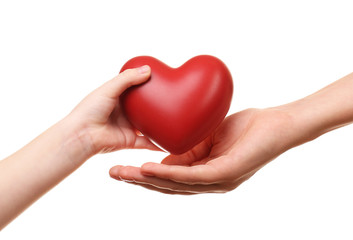 Obraz premium Heart in child and mother hands isolated on white