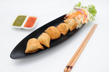 Pakoda on black plate, food stylist.