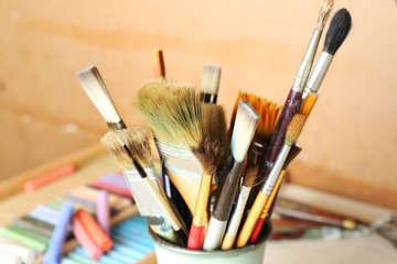 Fototapeta premium Paintbrushes with colorful chalk pastels in box