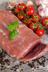 Fresh raw sirloin on stone plate with basil