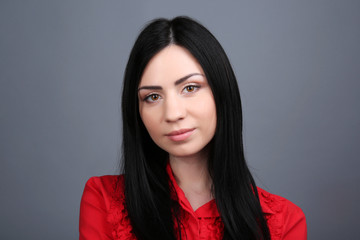 Fototapeta premium Portrait of young woman on grey background
