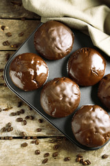 Tasty homemade chocolate muffins on wooden table