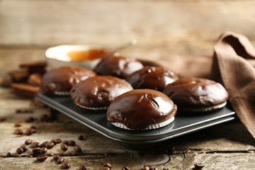 Tasty homemade chocolate muffins on wooden table