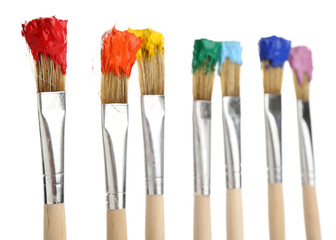 Brushes with colorful paints, isolated on white