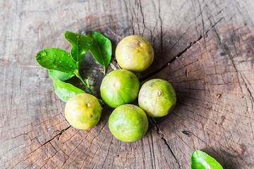 Fresh limes on wooden table
