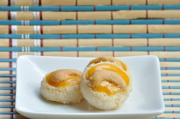 3 cashew nuts in white plate on mat