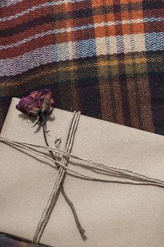 Present wrapped, decorated with a flower, on a wool blanket