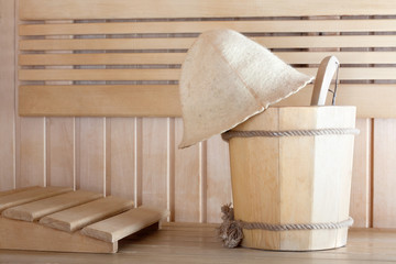 Obraz na płótnie Canvas Traditional wooden sauna for relaxation with bucket of water