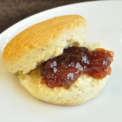 Splited butter scone with strawberry  in white plate