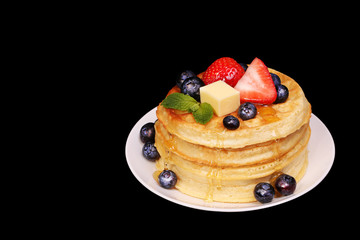 Waffles with Strawberry and Blueberry over back background