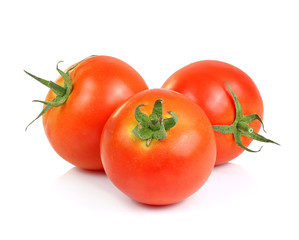 three fresh tomatoes with green leaves isolated on white backgro