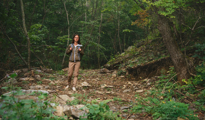 Hiker woman walking in summer forest