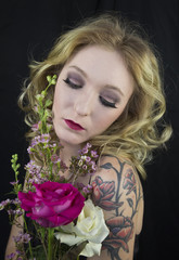 Pretty blond woman holding flowers