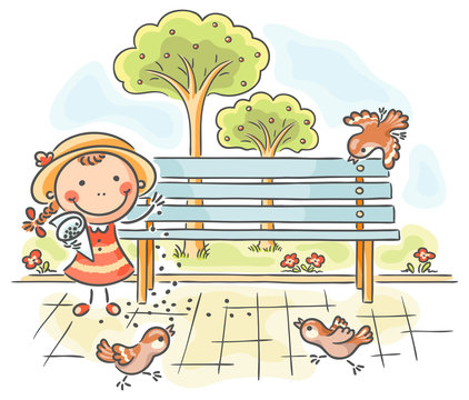 Girl feeding sparrows in the park