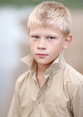 portrait of a little boy on the beach in summer