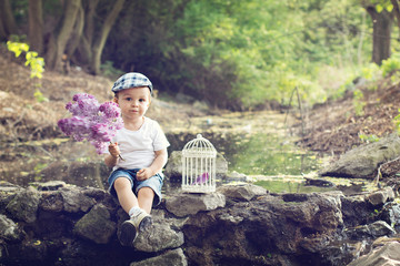 Naklejka na ściany i meble Boy with a lilac and a cage on a pond