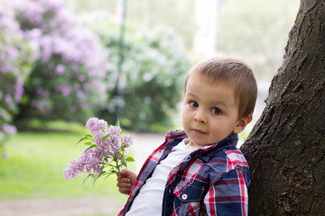 Boy in a park with lilac