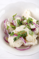 cauliflower salad in a white bowl