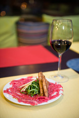 Beef Carpaccio Appetizer with Parmesan Cheese and ruccola salad