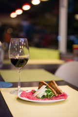 Beef Carpaccio Appetizer with Parmesan Cheese and ruccola salad