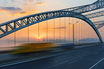 Fototapeta na wymiar road through the bridge with blue sky background of a city