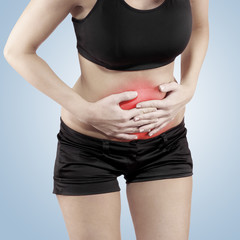 Woman with both palm around waistline to show pain on belly area