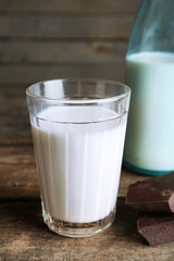 Glass and bottle of milk with chocolate chunks