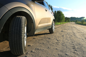 Fototapeta na wymiar fragment of the car on the road crossover SUV